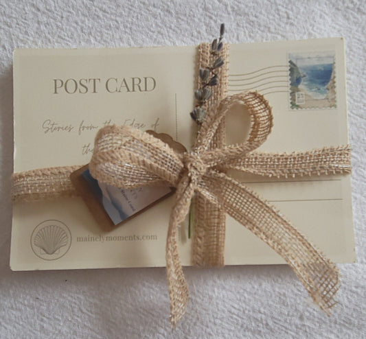 Postcard with a burlap ribbon on a textured surface